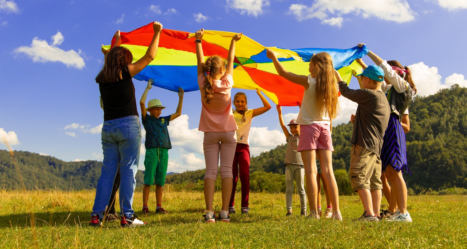 Children play in the sun - clean energy community. Photo by Artem Kniaz, Unsplash